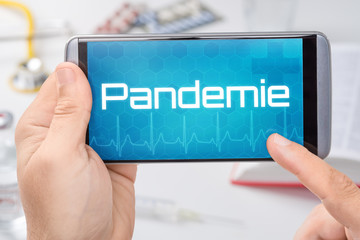 Smartphone mit dem Text Pandemie auf dem Display