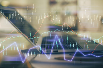 Forex graph hologram on table with computer background. Double exposure. Concept of financial markets.