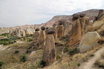 Fototapeta na wymiar Unusual stones from volcanic rocks in the Red Valley near the village of Chavushin in the Cappadocia region in Turkey.
