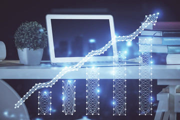 Financial chart drawing and table with computer on background. Double exposure. Concept of...