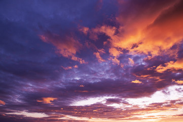 Beautiful red vibrant burning sunset sky with clouds