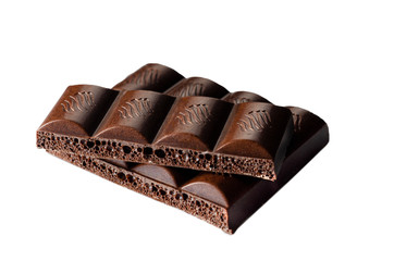 Pieces of porous chocolate on a white background