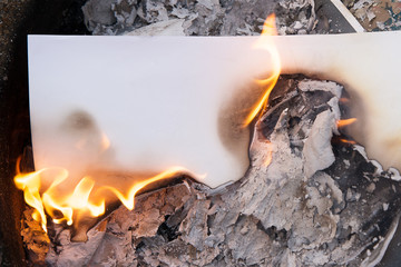 a sheet of white paper on fire