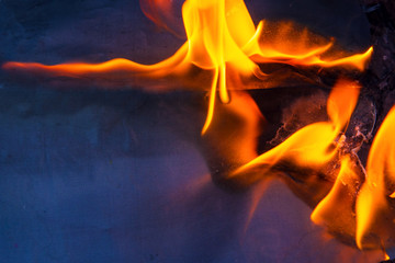 a sheet of blue paper on fire