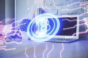 Double exposure of blockchain theme hologram and table with computer background. Concept of bitcoin crypto currency.