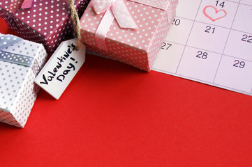 Mini gift boxes with wood tag and the calendar is marked on February 14.