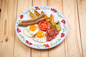 breakfast  - fried eggs, sausage, bacon and vegetables