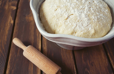 yeast dough on dark wooden surface