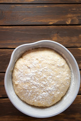 yeast dough on dark wooden surface