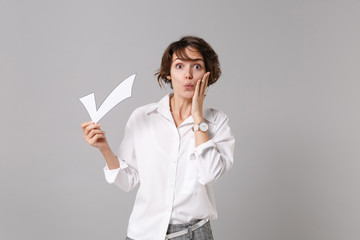 Amazed young business woman in white shirt posing isolated on grey background studio portrait....