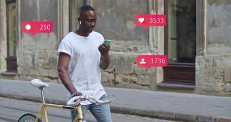 African American man using smartphone walking with stylish modern bike at old town. Animation with user interface with follower, comments, likes counting bubble from smartphone. Social media concept.