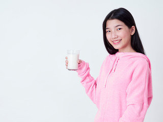 Teenage girls holding a glass of milk.