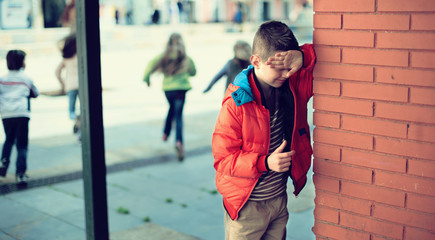 Children playing hide and seek in the schoolyard