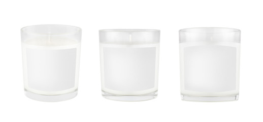 Three white candles in transparent glass with white blank label on isolated, mock up for branding...