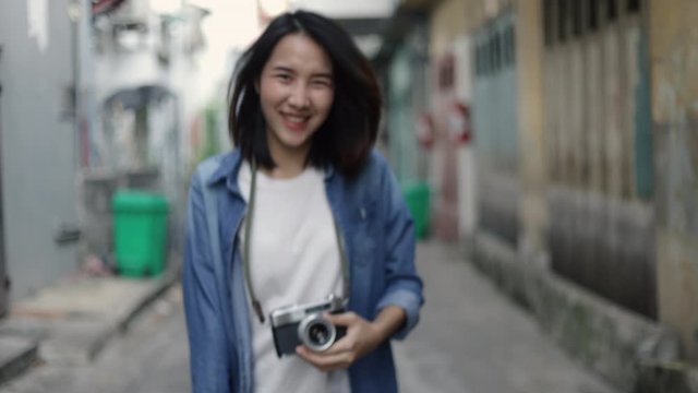 Attractive asian woman traveler calling you to come along with her enjoying traveling on vacation summer. Solo travel concept.