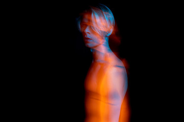 artistic long exposure portrait of naked torso young man. complimentary colors teal orange....