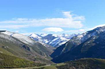 Winter landscape with snowy mountains and green valley with forest on a sunny day. Ancares, Lugo, Galicia, Spain. © JB