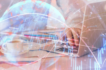 Forex graph with businessman working on computer in office on background. Concept of hardworking. Multi exposure.