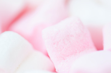 Pink fluffy heart shaped marshmallows candy background.