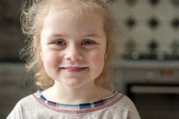 Girl with milk mustache after drinking milk