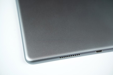 Brand new tablet isolated on white background, speaker detail