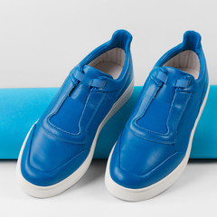men's blue shoes stand near the blue top hat, seasonal shopping concept isolated on white background