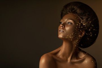 Fashion art portrait of model girl with holiday golden shiny professional makeup. beaty woman with...