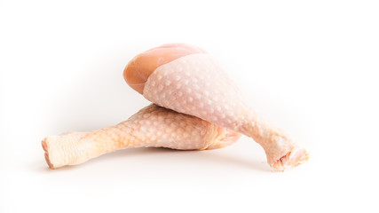 Two raw chicken legs on a white background. Isolated. Macro photo. Close view. 
