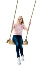 Beautiful teen school girl swinging on a swing. Concept summer v