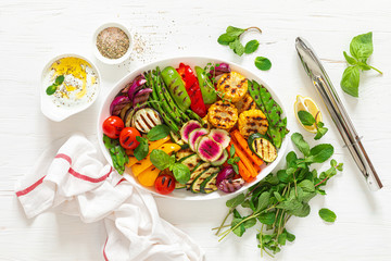 Grilled vegetables on a white plate, top view