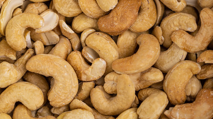 Roasted cashew nuts. Full frame macro photo.