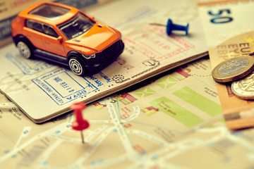 travel concept - small toy car on the map