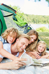 Parents and children in tent on summer vacation