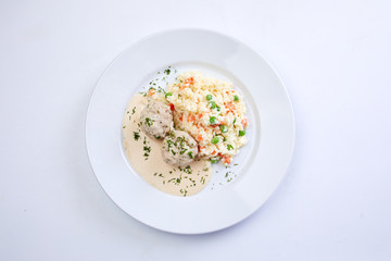 meatballs with rice and vegetables on the white background