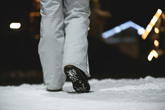 Walking Away Woman Legs Close Up On Winter Snow Background At Night.