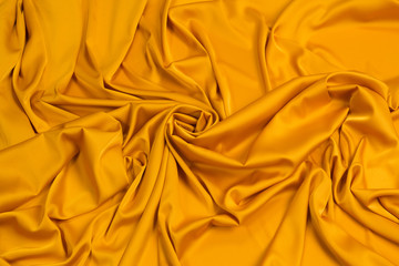 Fabric satin silk drapery. Yellow textile