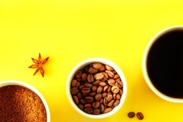 Three white cups with ground coffee, coffee beans and black brewed coffee in the rays of bright sunlight, sunset, dawn on a yellow background. Close-up, top view, flat lay, copy space for text.