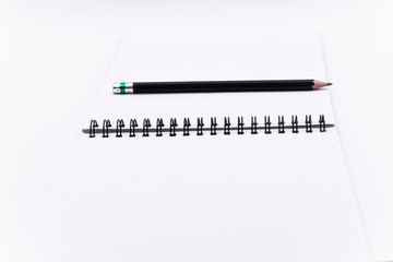 book and pencil opened blank square ctalogue at white design paper background.