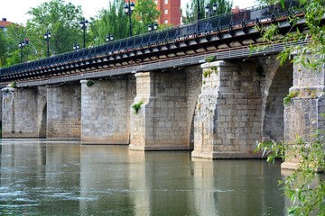 An old bridge reflected on the river