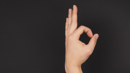 The A-Ok Hand Sign on black background.