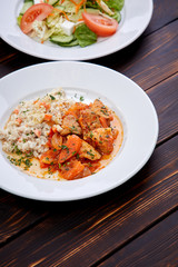 meat with barley and salad on the wooden background