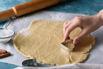 process of making cookie dough heart shape on kitchen blue table