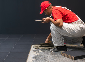 Floor ceramic tiles installation. Create, arranging.