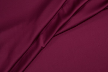 Fabric satin silk drapery. Textile purple