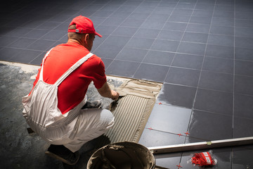 Floor ceramic tiles installation. Create, arranging.