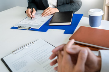 Interview job concept, attractive candidate job seeker in suit answers employee for a business vacancy interviewing.