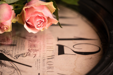 Retro pink rose on a clock face, clock hands