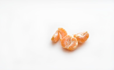 Mandarin slices on a white background