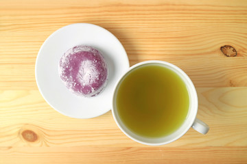 Top View of Cup of Green Tea with Japanese Purple Sweet Potato Daifuku or Red Bean Paste Filling Rice Cake