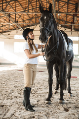 Beautiful woman wearing hat with horse
